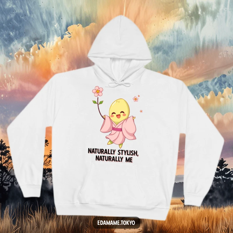 Funny hoodie depicting a happy edamame in a pale pink kimono, joyfully twirling with a blossom, offering comfort and humor.